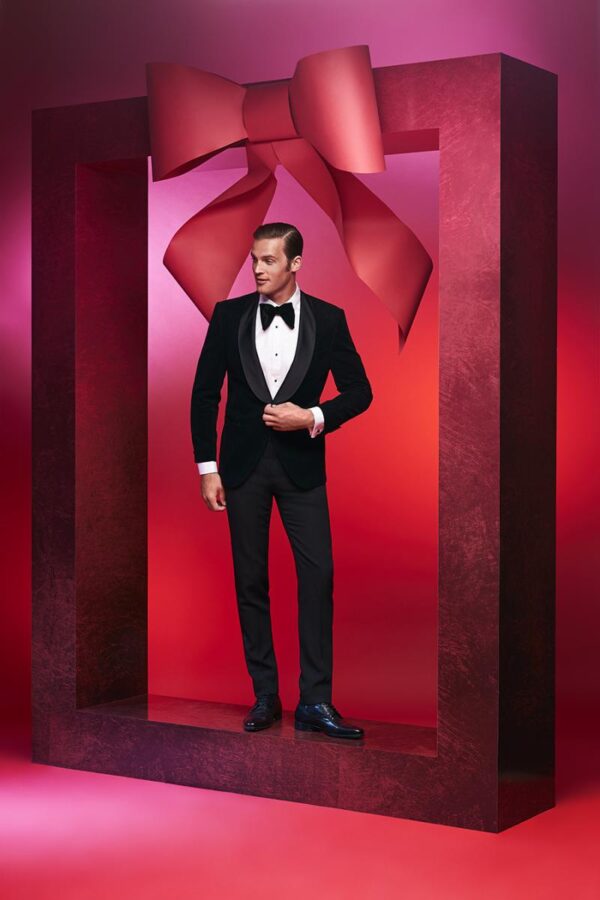 A Man Taking A Pose Under The Bow Tie Frame