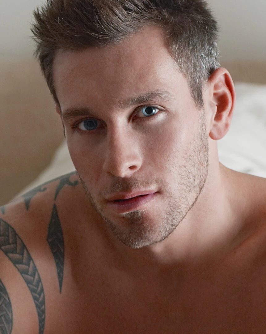 Shirtless Man Sitting on Bed